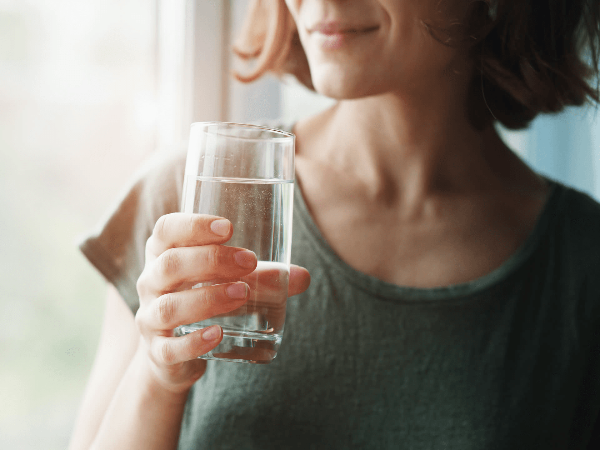 Woman drinking water for better digestion