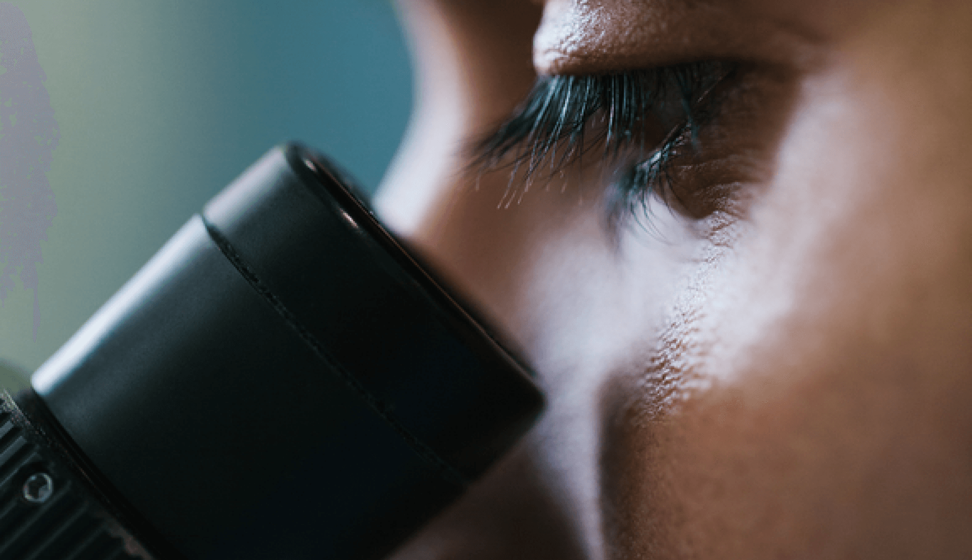 Person looking through microscope eyepiece