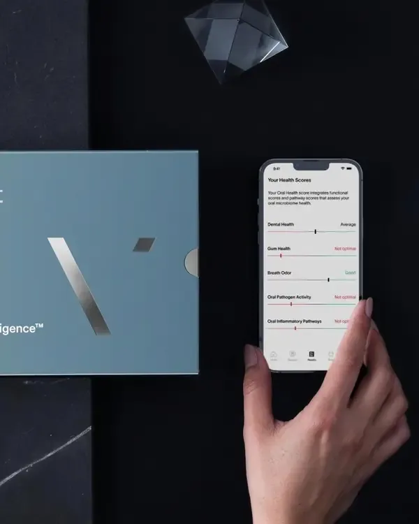 A Viome kit beside a phone running the Viome app